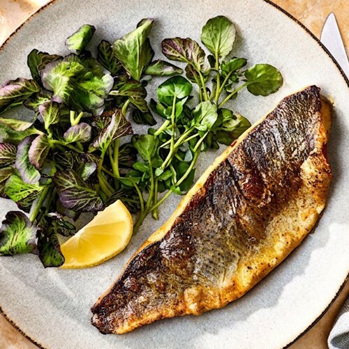 Photo of Simply Roasted Branzino from Chios Taverna by Michael Symon